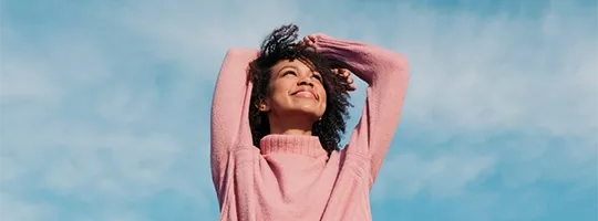 Junge Frau freut sich über Multi Benefits von Pluxee.